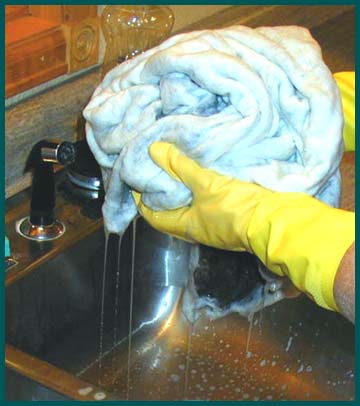 squeezing out the soapy water